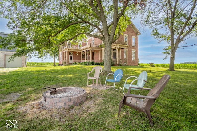 9665 N County Rd 250 E, Frankfort, IN 46041 - view of green lawn with a balcony and an outdoor fire pit