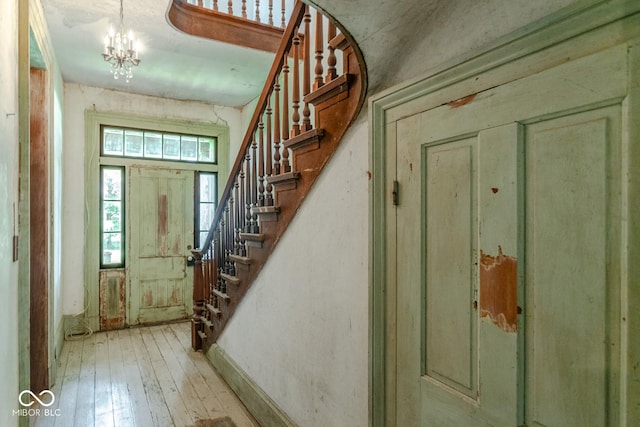 9665 N County Rd 250 E, Frankfort, IN 46041 - entrance foyer with stairs, light wood-style floors, and a chandelier