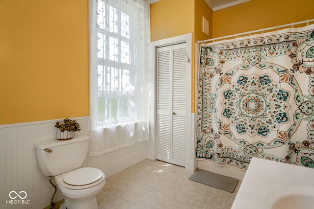 9665 N County Rd 250 E, Frankfort, IN 46041 - bathroom featuring a closet, a wainscoted wall, healthy amount of natural light, and curtained shower