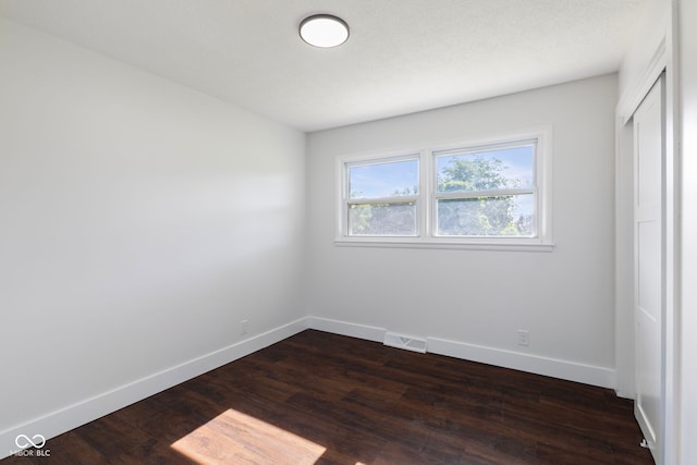 4622 S Franklin Rd, Indianapolis, IN 46239 - unfurnished bedroom featuring dark wood-style floors and a closet
