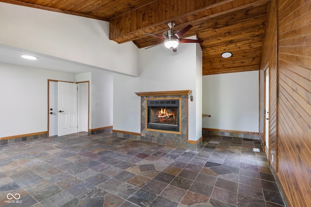 4622 S Franklin Rd, Indianapolis, IN 46239 - unfurnished living room featuring wooden ceiling, stone tile flooring, a ceiling fan, a tiled fireplace, and high vaulted ceiling