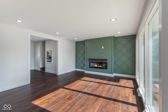 4622 S Franklin Rd, Indianapolis, IN 46239 - unfurnished living room featuring dark wood-style floors, a large fireplace, and recessed lighting