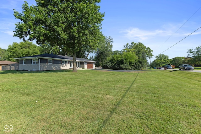 4622 S Franklin Rd, Indianapolis, IN 46239 - view of yard with an attached garage and driveway