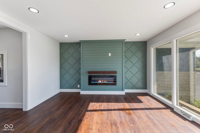 4622 S Franklin Rd, Indianapolis, IN 46239 - unfurnished living room with wood finished floors, a glass covered fireplace, and recessed lighting