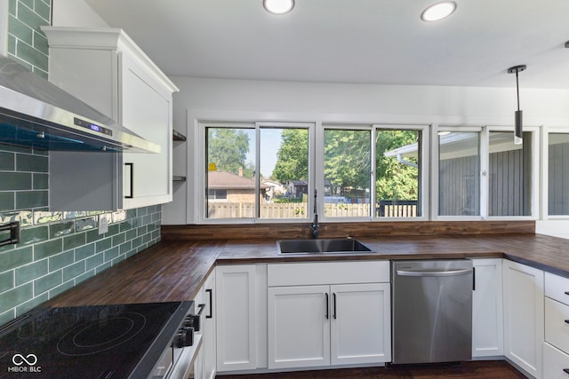 4622 S Franklin Rd, Indianapolis, IN 46239 - kitchen featuring butcher block counters, dishwasher, wall chimney exhaust hood, tasteful backsplash, and recessed lighting
