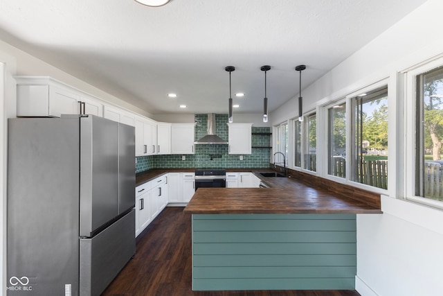 4622 S Franklin Rd, Indianapolis, IN 46239 - kitchen with freestanding refrigerator, wall chimney exhaust hood, healthy amount of natural light, a peninsula, and recessed lighting