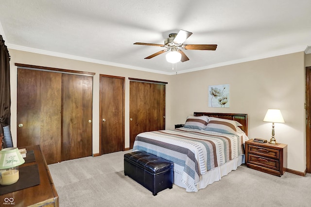 8413 Slippery Elm Ct, Indianapolis, IN 46227 - bedroom featuring light carpet, two closets, crown molding, and a ceiling fan