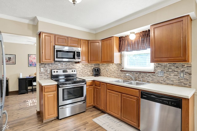 8413 Slippery Elm Ct, Indianapolis, IN 46227 - kitchen featuring appliances with stainless steel finishes, light wood finished floors, light countertops, tasteful backsplash, and ornamental molding