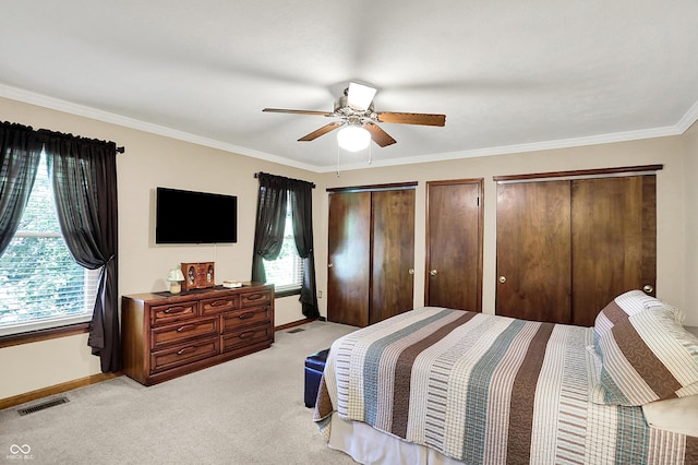 8413 Slippery Elm Ct, Indianapolis, IN 46227 - bedroom featuring light colored carpet, ornamental molding, a ceiling fan, and multiple closets