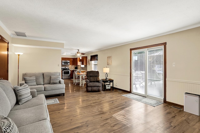 8413 Slippery Elm Ct, Indianapolis, IN 46227 - living area with dark wood-type flooring, ornamental molding, ceiling fan, and a textured ceiling
