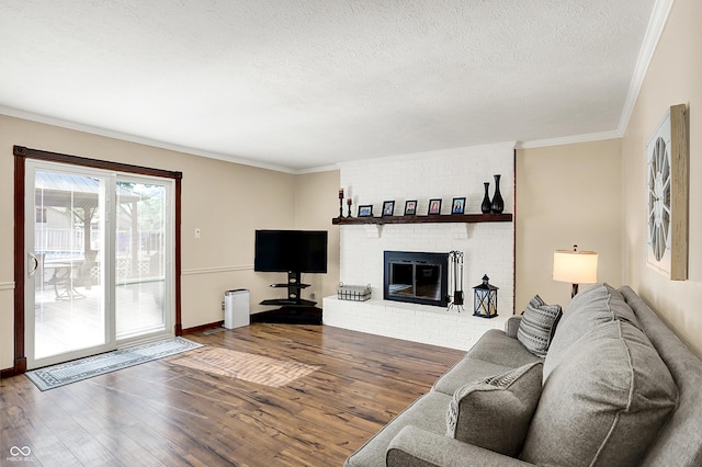8413 Slippery Elm Ct, Indianapolis, IN 46227 - living area with wood finished floors, ornamental molding, a textured ceiling, and a fireplace