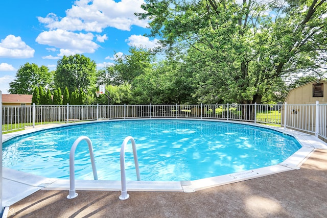 8413 Slippery Elm Ct, Indianapolis, IN 46227 - view of swimming pool featuring view of scattered trees and an outbuilding