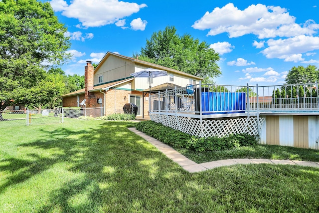 8413 Slippery Elm Ct, Indianapolis, IN 46227 - rear view of property featuring a chimney, a deck, a fenced backyard, and brick siding