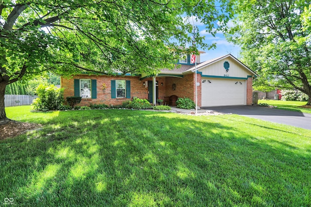 8413 Slippery Elm Ct, Indianapolis, IN 46227 - view of front facade featuring brick siding, asphalt driveway, and an attached garage