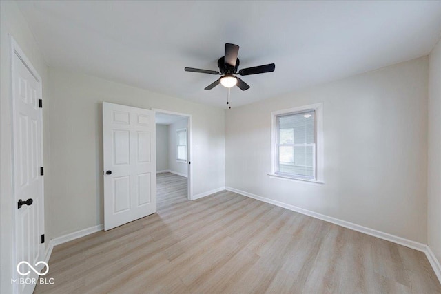 3725 Carson Ave, Indianapolis, IN 46227 - unfurnished bedroom with light wood-type flooring, multiple windows, and a ceiling fan