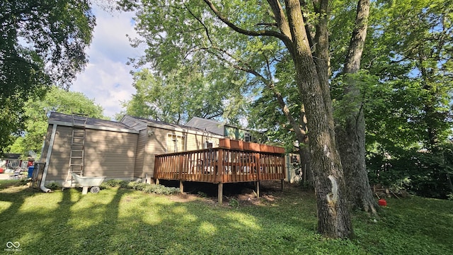 6714 Granner Ct, Indianapolis, IN 46221 - back of house featuring a wooden deck and a lawn