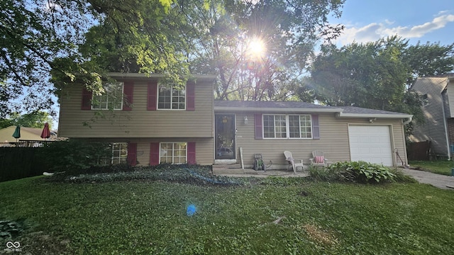 6714 Granner Ct, Indianapolis, IN 46221 - split level home with an attached garage, a front yard, and concrete driveway