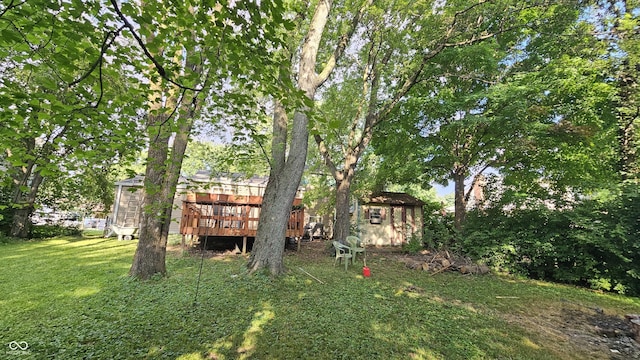 6714 Granner Ct, Indianapolis, IN 46221 - view of grassy yard with a deck and a storage unit