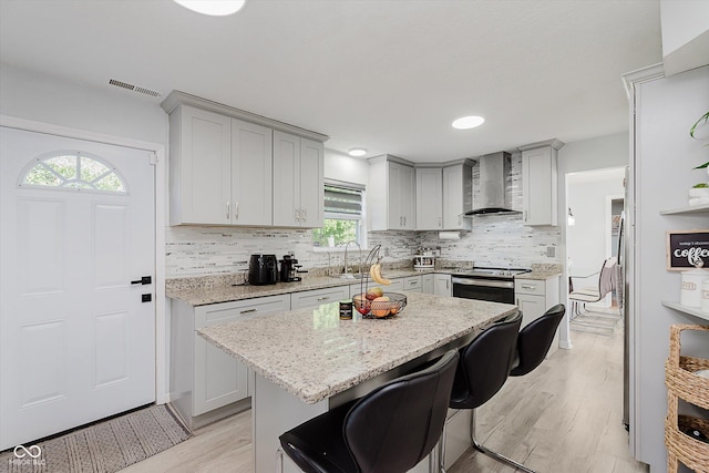 6136 Sandcherry Dr, Indianapolis, IN 46236 - kitchen with wall chimney exhaust hood, stainless steel electric range oven, healthy amount of natural light, tasteful backsplash, and recessed lighting