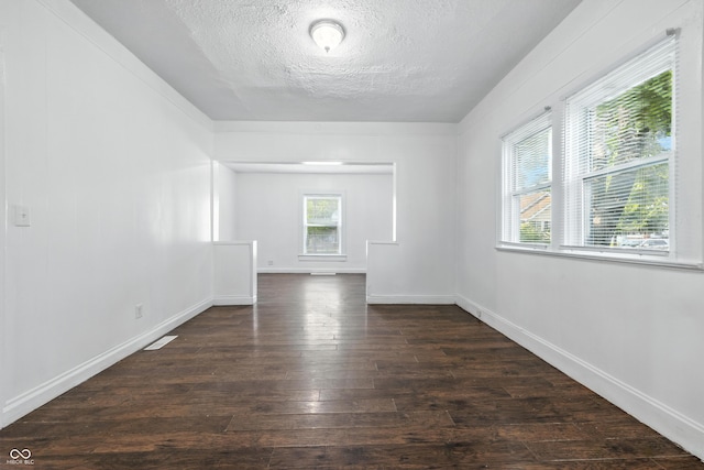 1621 E Kelly St, Indianapolis, IN 46203 - unfurnished room featuring dark wood-type flooring and a textured ceiling