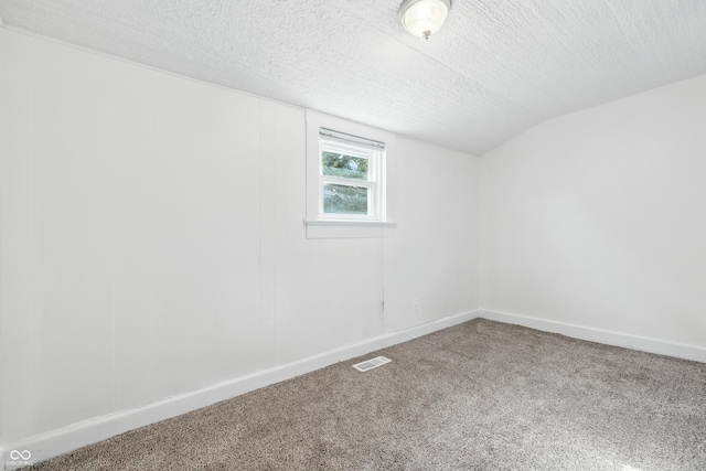 1621 E Kelly St, Indianapolis, IN 46203 - empty room featuring a textured ceiling, carpet floors, and lofted ceiling