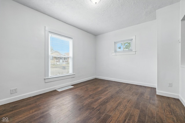 1621 E Kelly St, Indianapolis, IN 46203 - empty room featuring dark wood finished floors and a textured ceiling