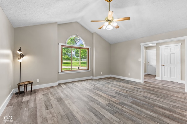 4359 N State Road 75th Hwy, North Salem, IN 46165 - unfurnished living room featuring ceiling fan, wood finished floors, lofted ceiling, and a textured ceiling