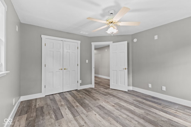 4359 N State Road 75th Hwy, North Salem, IN 46165 - unfurnished bedroom with a closet, wood finished floors, and a ceiling fan