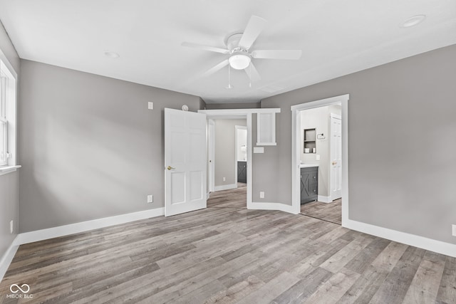 4359 N State Road 75th Hwy, North Salem, IN 46165 - unfurnished bedroom featuring wood finished floors, ensuite bath, and ceiling fan
