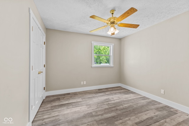 4359 N State Road 75th Hwy, North Salem, IN 46165 - unfurnished bedroom featuring a textured ceiling, wood finished floors, a ceiling fan, and a closet
