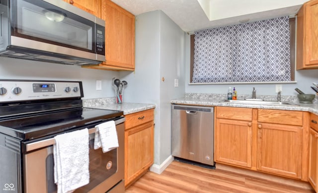 2725 Palo Verde Ct, Indianapolis, IN 46227 - kitchen featuring appliances with stainless steel finishes, light wood-style flooring, and light countertops