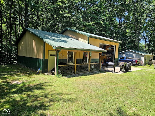 9713 E Poplar Dr, Brazil, IN 47834 - view of front of home with a front yard, a metal roof, and a garage