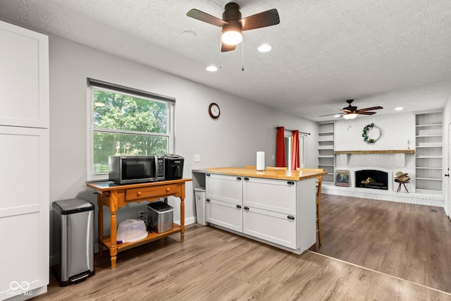 296 Summit Ridge Dr, Greenwood, IN 46142 - kitchen featuring ceiling fan, a textured ceiling, light wood-type flooring, butcher block countertops, and white cabinets