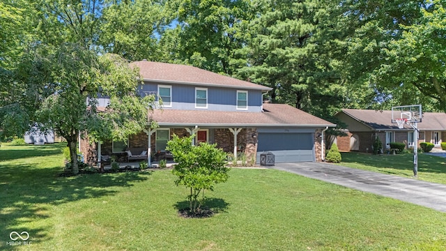 296 Summit Ridge Dr, Greenwood, IN 46142 - view of front of house featuring a garage, a front yard, driveway, covered porch, and a shingled roof