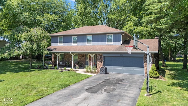 296 Summit Ridge Dr, Greenwood, IN 46142 - view of front of property with covered porch, asphalt driveway, a front lawn, a garage, and brick siding