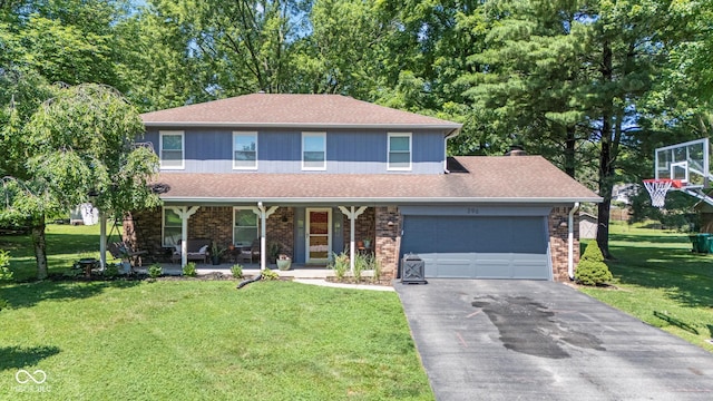 296 Summit Ridge Dr, Greenwood, IN 46142 - view of front of home featuring covered porch, a garage, driveway, a front yard, and a shingled roof