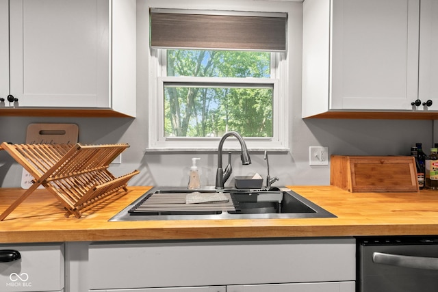 296 Summit Ridge Dr, Greenwood, IN 46142 - kitchen with wooden counters, stainless steel dishwasher, and white cabinetry