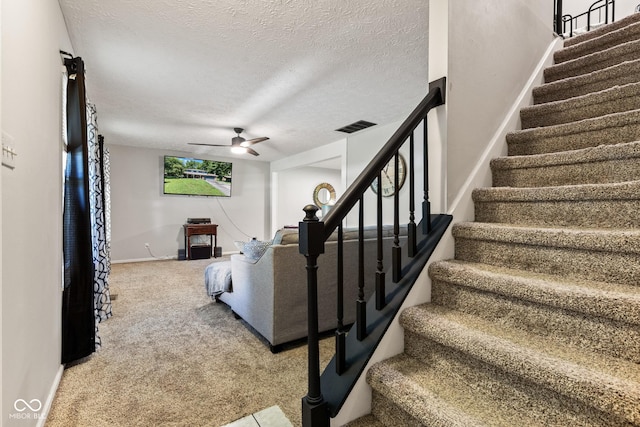 296 Summit Ridge Dr, Greenwood, IN 46142 - staircase featuring a textured ceiling, a ceiling fan, and carpet flooring