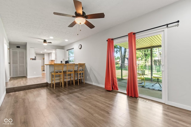 296 Summit Ridge Dr, Greenwood, IN 46142 - living room with wood finished floors, a ceiling fan, recessed lighting, and a textured ceiling
