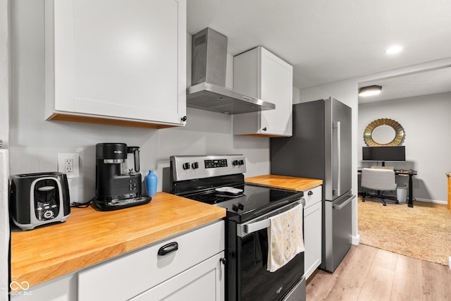 296 Summit Ridge Dr, Greenwood, IN 46142 - kitchen with wall chimney range hood, stainless steel appliances, wood counters, white cabinets, and light wood-type flooring