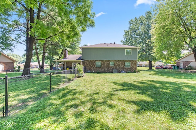 296 Summit Ridge Dr, Greenwood, IN 46142 - back of house featuring brick siding, stone siding, and a chimney