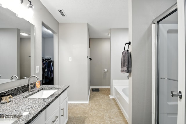 8147 Retreat Ln, Indianapolis, IN 46259 - full bathroom featuring vanity, a garden tub, a spacious closet, a shower stall, and tile patterned floors