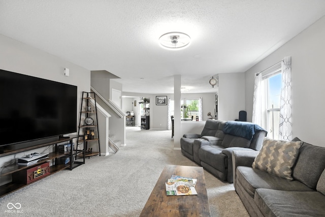 8147 Retreat Ln, Indianapolis, IN 46259 - living area with carpet, stairway, and a textured ceiling