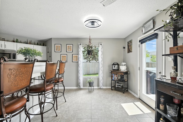 8147 Retreat Ln, Indianapolis, IN 46259 - dining area featuring a textured ceiling and light tile patterned floors