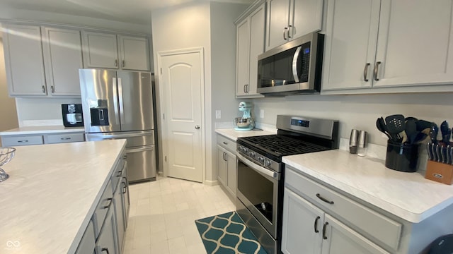 4081 Lotus St, Plainfield, IN 46168 - kitchen with stainless steel appliances, gray cabinets, and light countertops