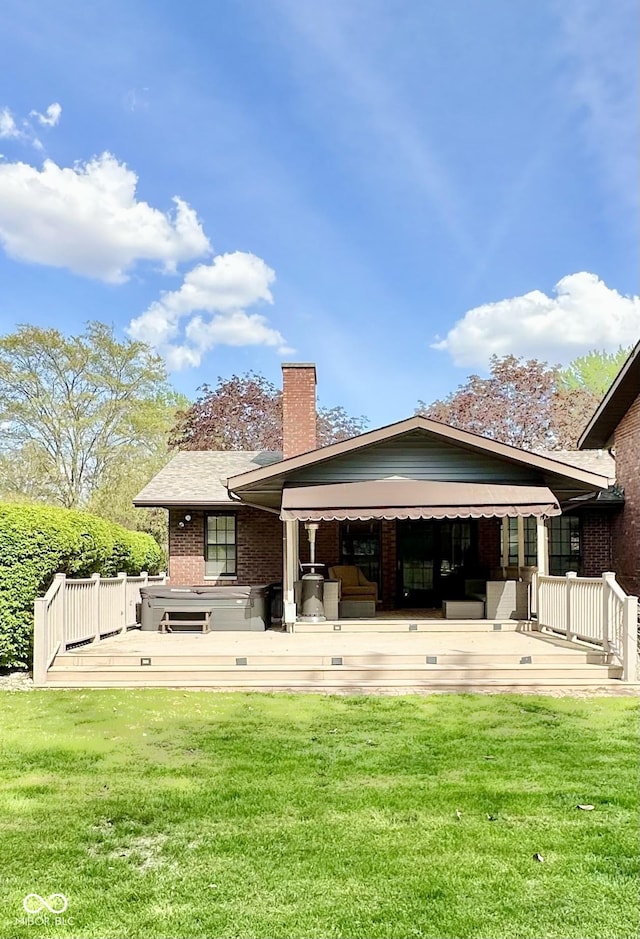 401 Dellwood Dr, Covington, IN 47932 - rear view of property with brick siding, a chimney, a yard, and a deck