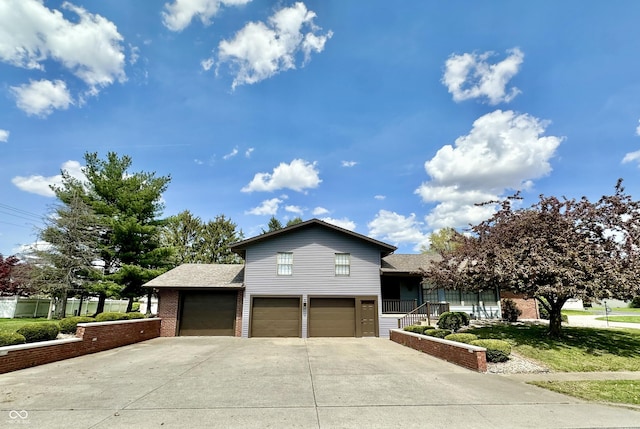 401 Dellwood Dr, Covington, IN 47932 - tri-level home featuring driveway, a garage, brick siding, and roof with shingles
