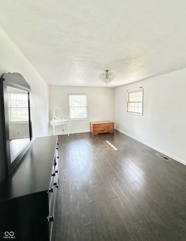 401 Dellwood Dr, Covington, IN 47932 - unfurnished living room with dark wood-style flooring and a textured ceiling