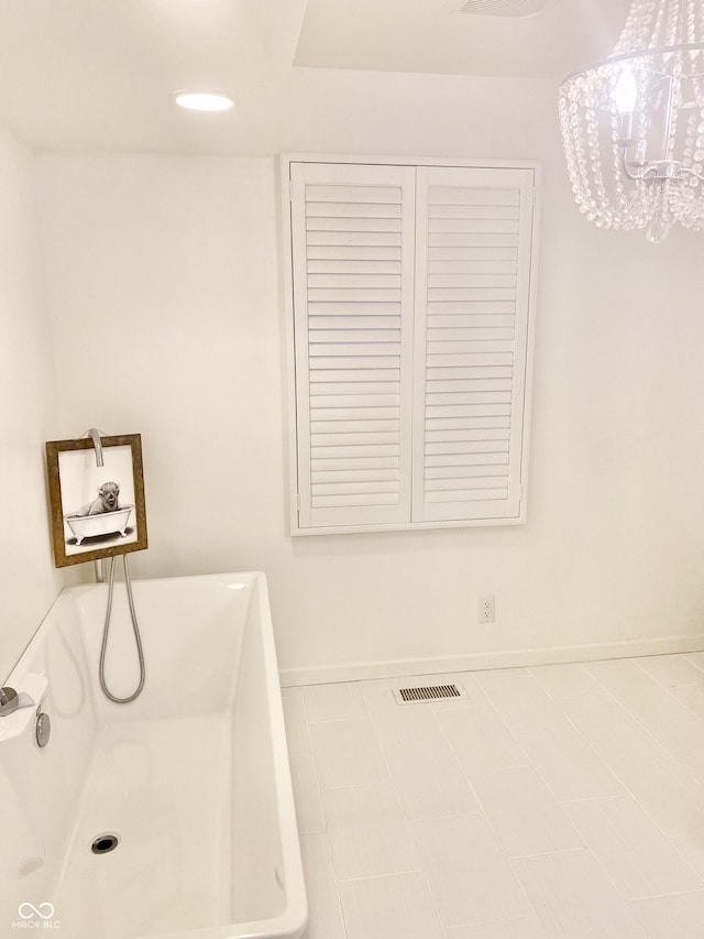 401 Dellwood Dr, Covington, IN 47932 - bathroom with a bathtub and a chandelier