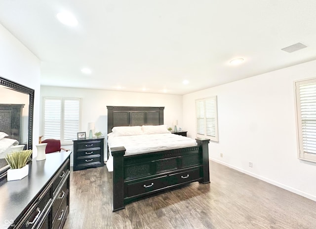 401 Dellwood Dr, Covington, IN 47932 - bedroom with dark wood finished floors, multiple windows, recessed lighting, and a fireplace